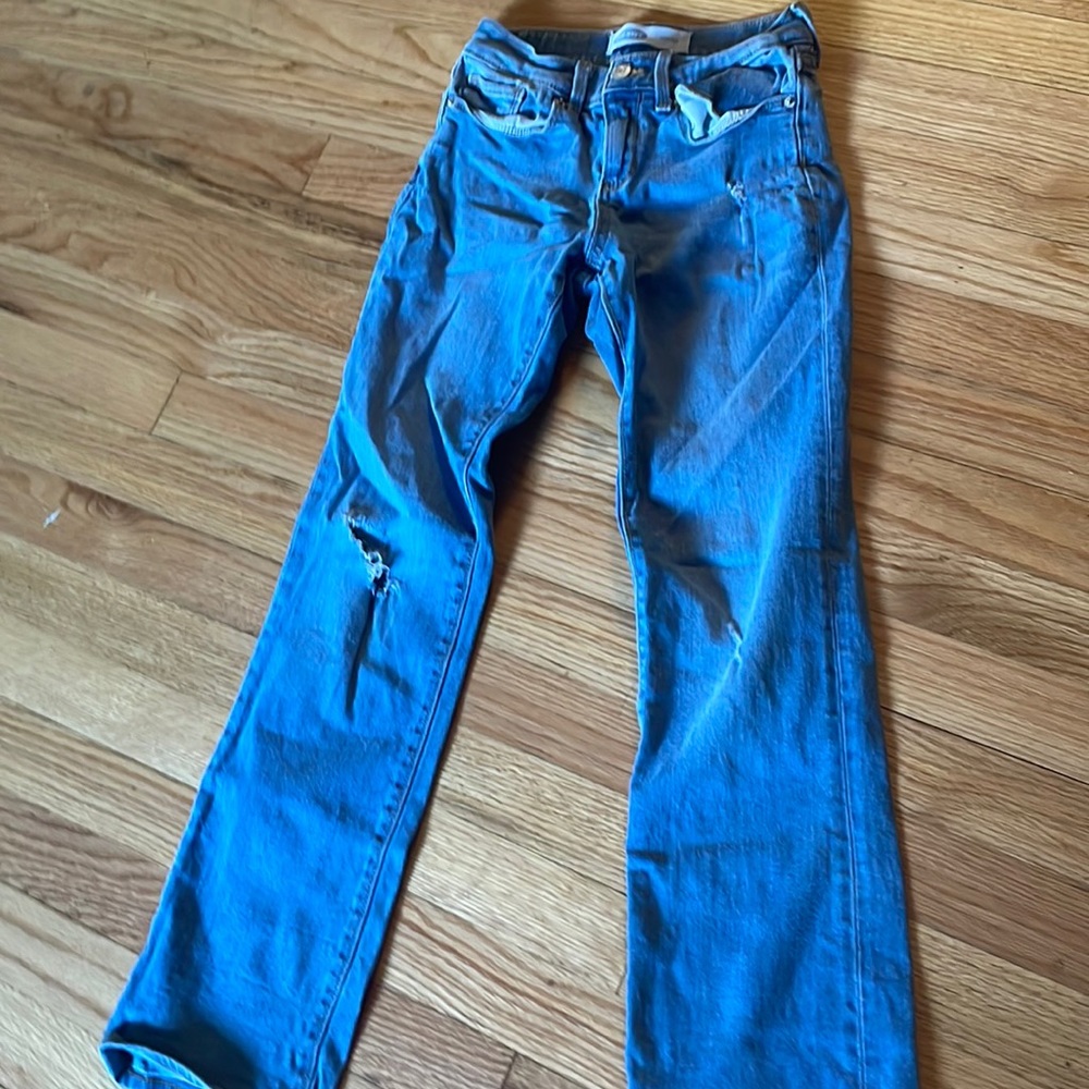 they are blue boot jeans, with two rips on the nee.